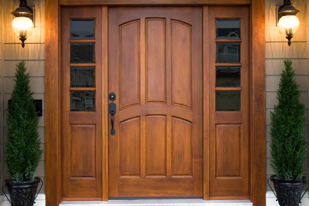 A beautiful wooden door graces the entrance to a west coast contemporary home