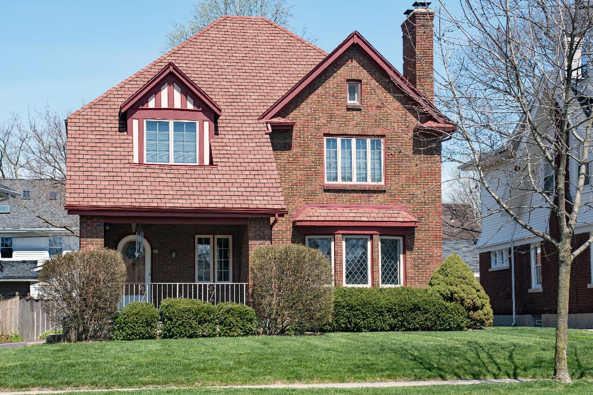 Brick house with red shingle roof