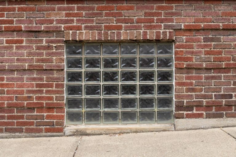 Glass block basement window in an old red brick building, Are Glass Block Windows Soundproof?