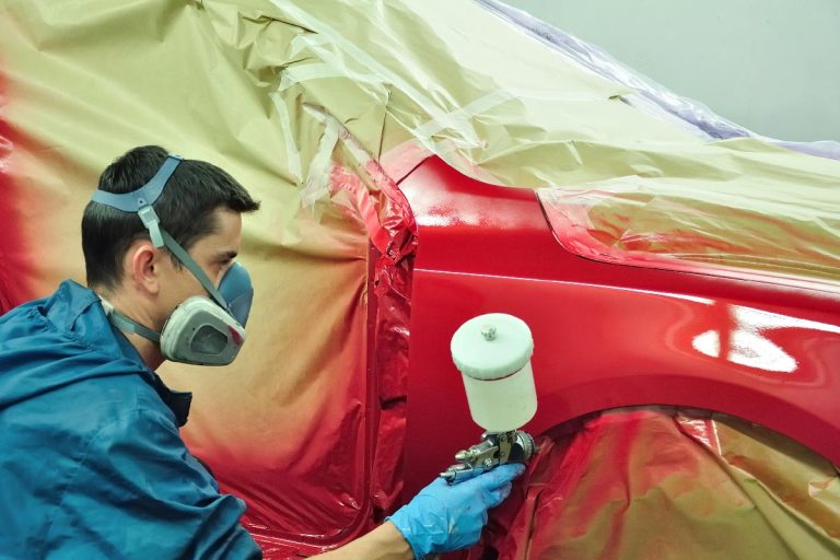 Man painting a red car, Can You Paint A Car With Exterior House Paint?