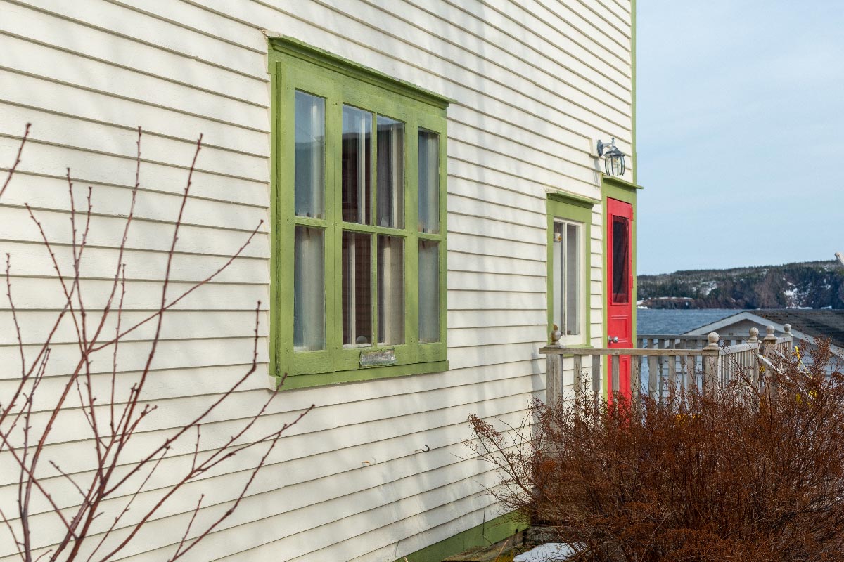 Vintage house with light green window trim