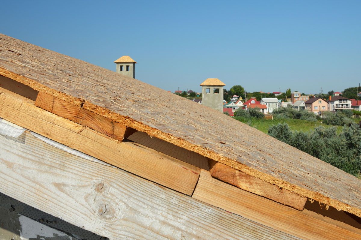 a roof under construction on the stage of roof sheathing, installed OSB roof deck over timber planks and wood braces