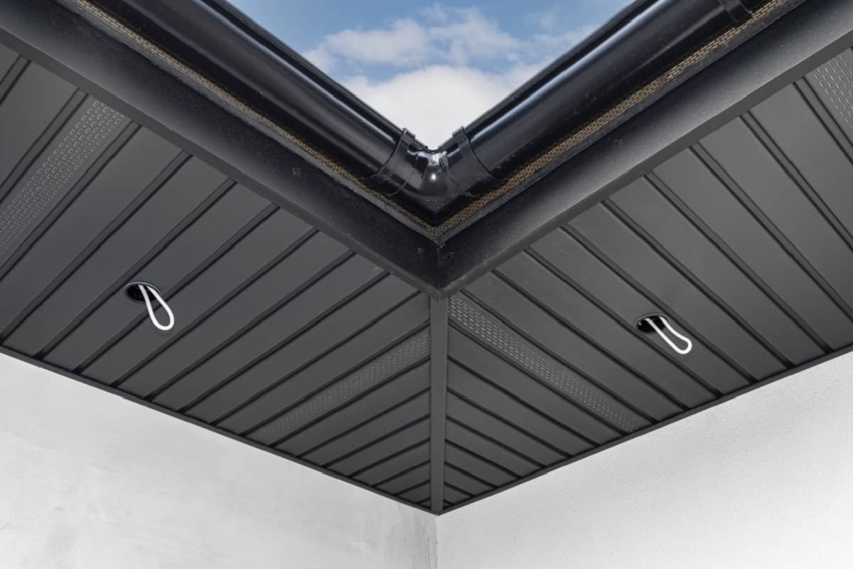 A modern graphite herringbone roof lining is attached to the trusses, visible cables and holes for LED lighting - Decorative Roof Trim Molding