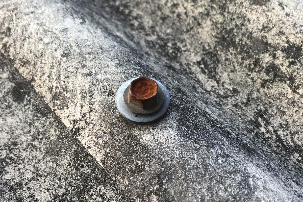 Rusty locking bolt on the corrugated roof