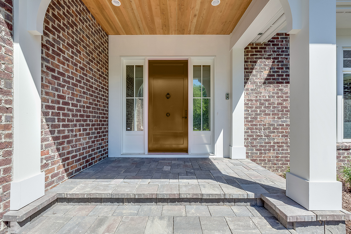 Stone porch leading up to bright capola door
