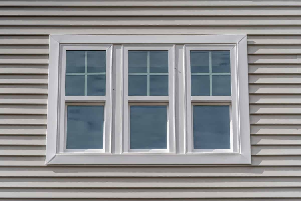 Triple hung window with fixed top sash and bottom sash that slides up