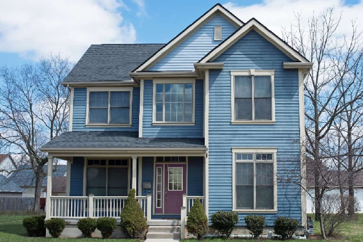 What Are The Pros And Cons Of Having Vinyl Siding - Blue Two Story House with Purple Door