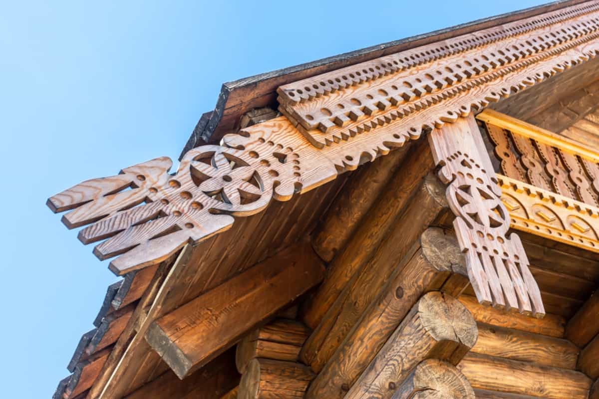 Wooden handmade carved decorations on the roof of a traditional russian wooden house - Frieze Boards