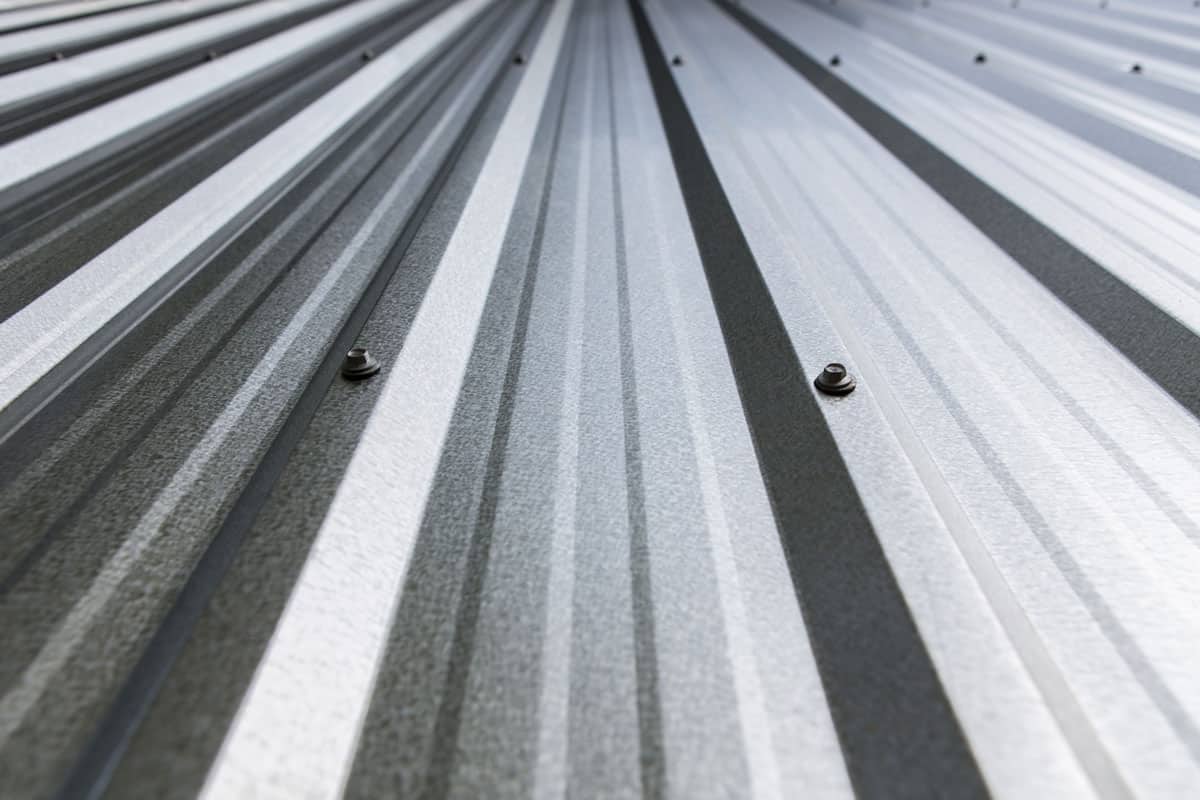 metal sheet of zinc roof on the top of the house, shiny silver colored roof