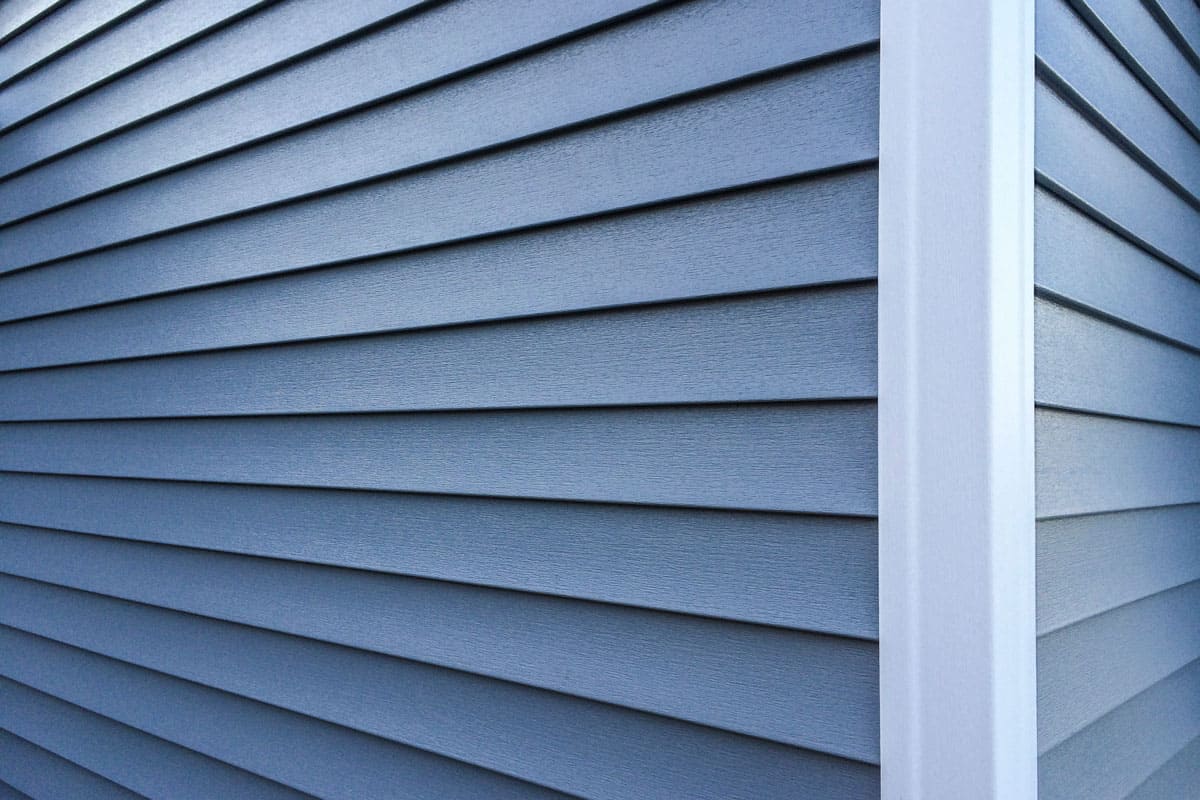 photo of a wall outside the huge hose with dark blue vinyl sidings