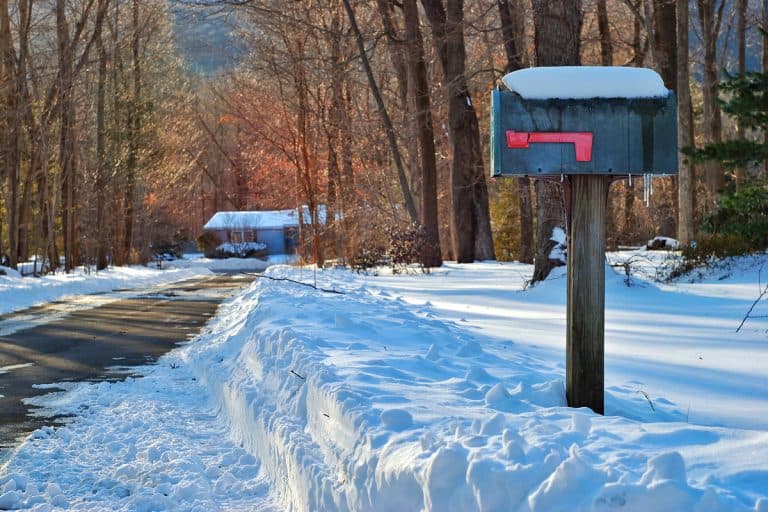 A mailbox at the side of a driveway after a snow storm , How To Install Mailbox Post In Frozen Ground