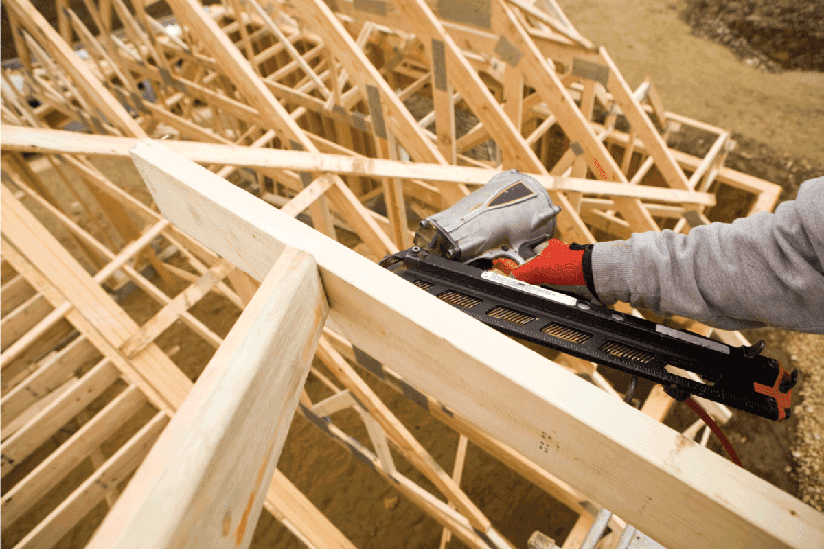 Builder Using Pneumatic Framing Nailer to Secure Roof Truss