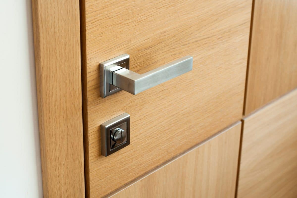Entrance wooden doors and handle. Door knob.
