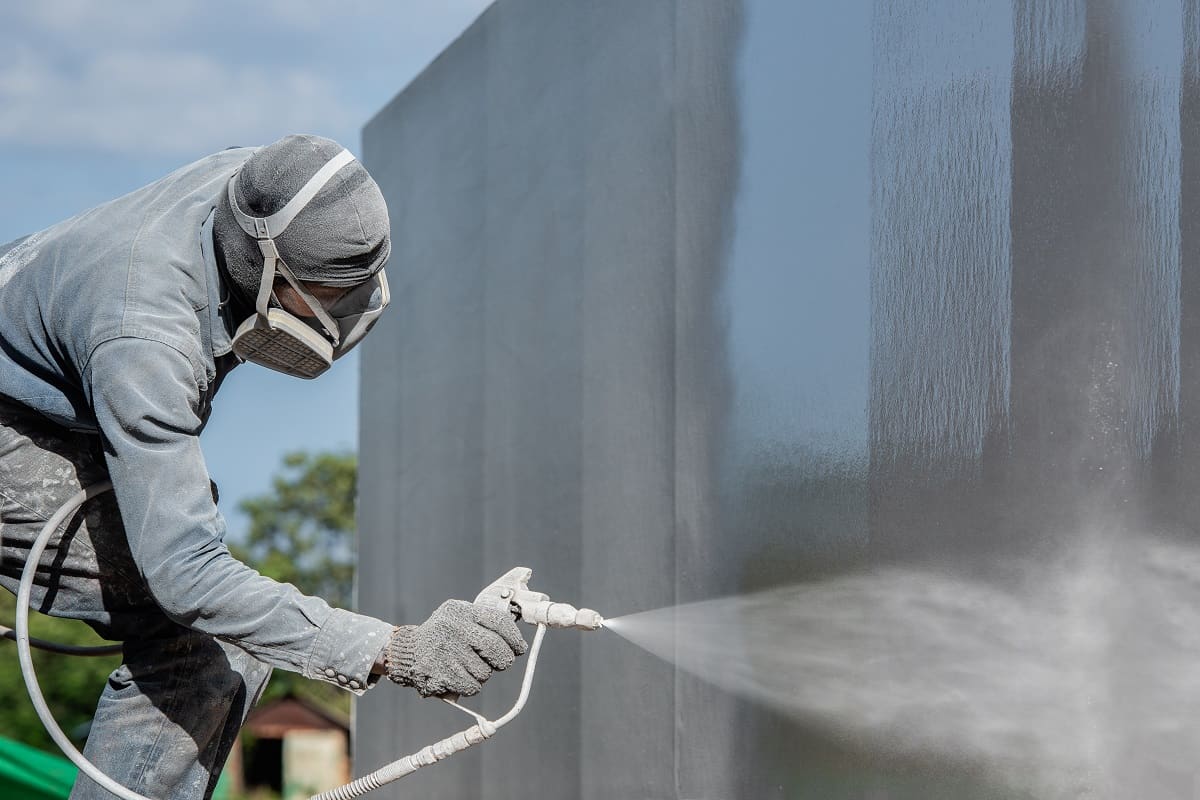 How Much Does It Cost To Paint A 2-Story House Exterior - Airless Spray Painting, Worker painting on steel wall surface