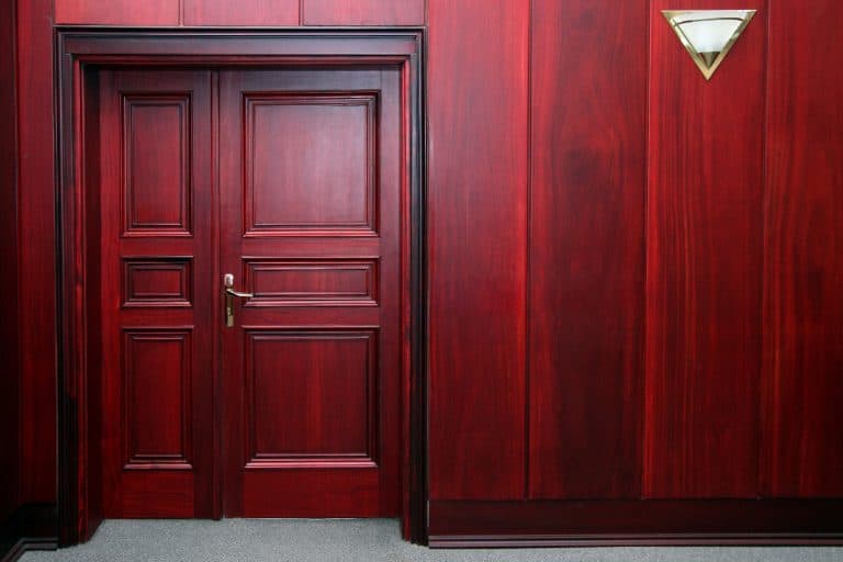 Luxury mahogany wooden interior with closed door, Do Wood Doors Reduce Noise?