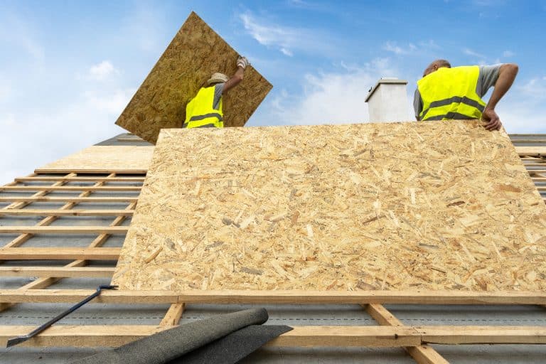 A man holding in plywood or osb panel on modern building rooftop, What Size Roofing Nails For 1/2 Plywood?