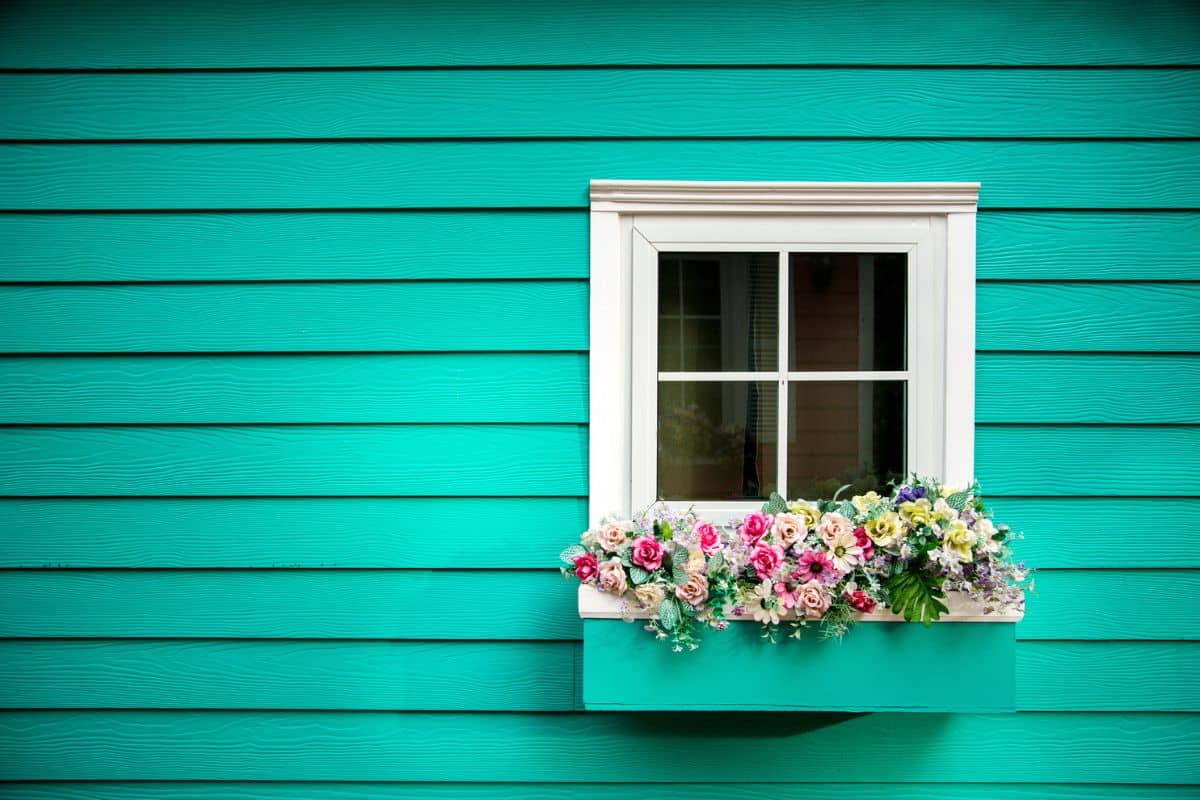 One window of wooden house, Decorated With Fresh Flowers

