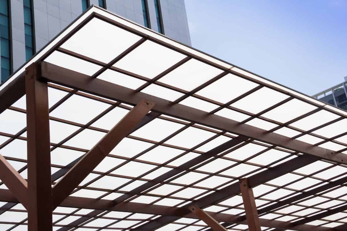 Polycarbonate Roofing use for house decoration, car park lot or out door walk way path, transparent roof with wooden and brown steel structure.