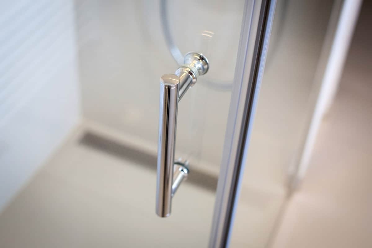 Shower door with silver handle in a luxury bathroom