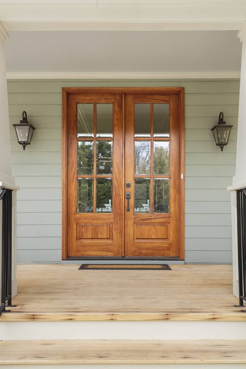 What Is The Best Way To Choose The Right Front Door - Double wooden doors to a green home
