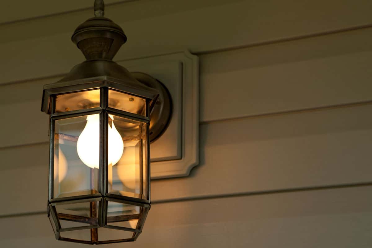 close up photo of a porch light attached on the wall outside the house