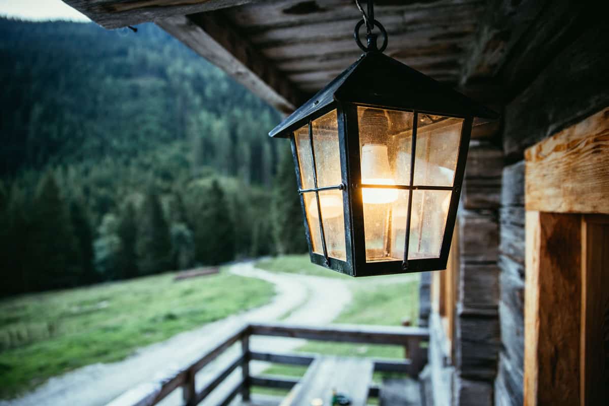 peaceful photo of a place in the mountain porch lights attached on outside the house