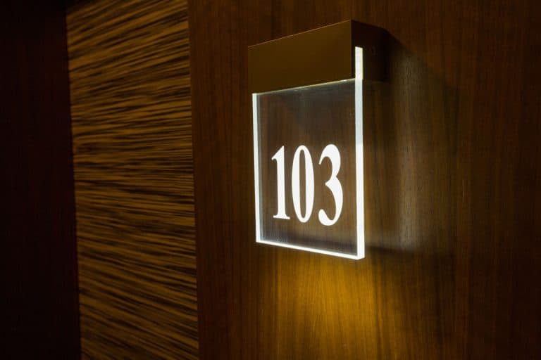 photo of a hotel-room-number-on-wooden-wall, Do House Numbers Need To Be Lit?