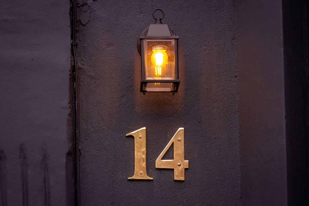 photo of a house-number-14-lit-above-by