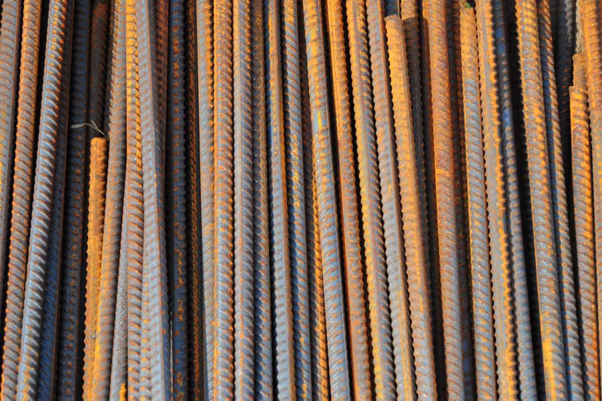 A close-up of reinforcing steel bars, rebars used to strengthen the concrete footings, foundations, concrete slabs and masonry constructions. Construction materials, rebars background.
