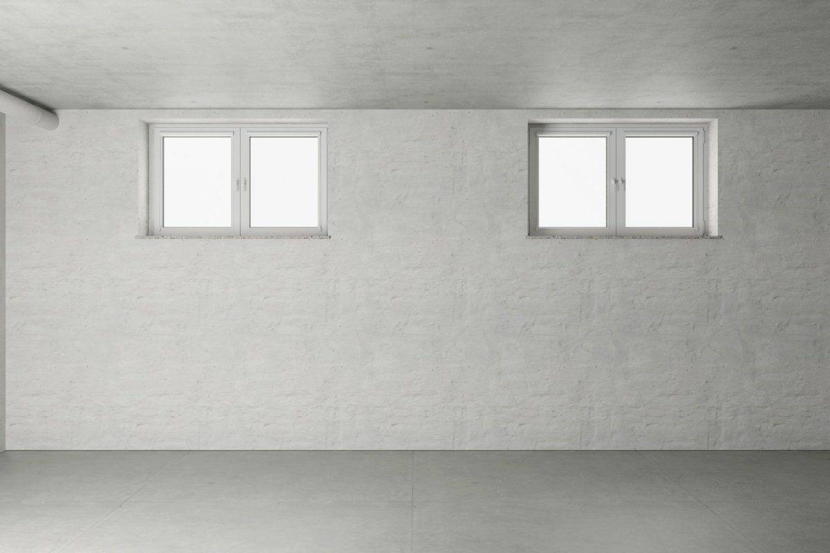 Empty room in the basement with two windows from a new house (3d rendering)
