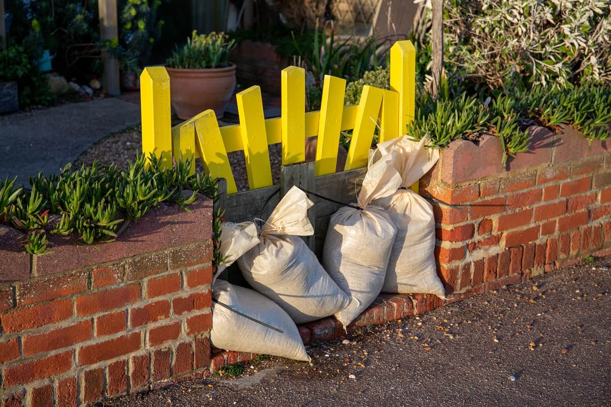 Sandbags by a yellow front gate