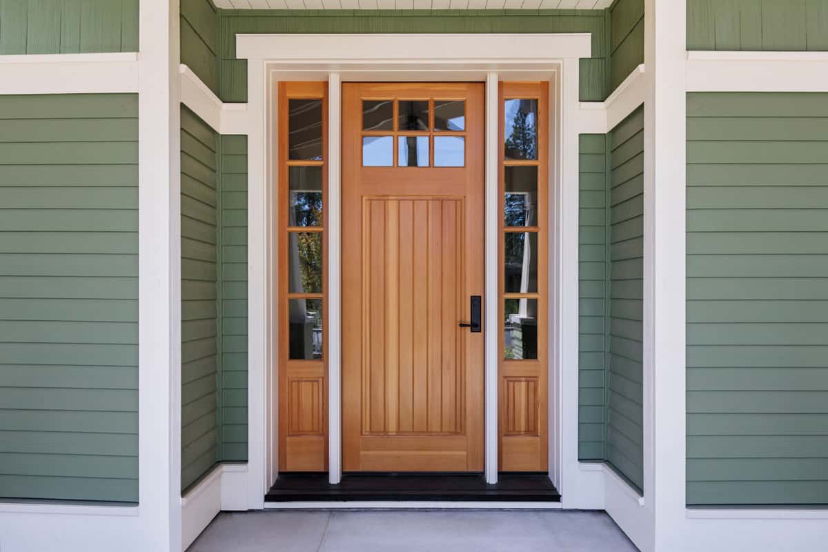Brown front door, front view with green trim. Bend, Oregon.