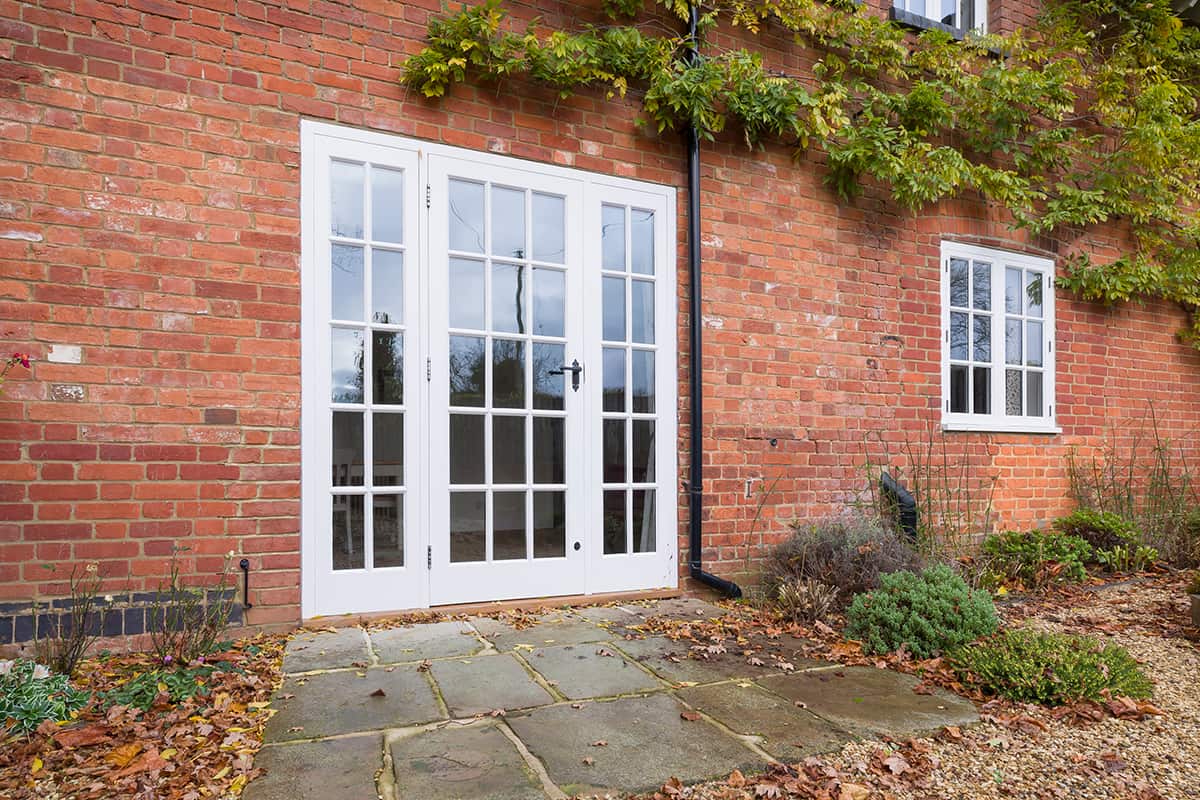 Wooden French doors and a York stone patio