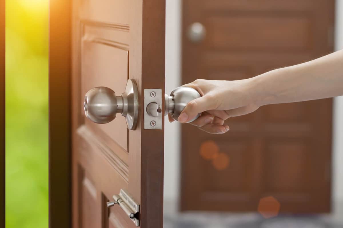 women hand open door knob or opening the door