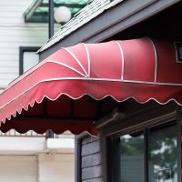 Red old awning on the front door, How To Attach A Door Awning To Vinyl Siding